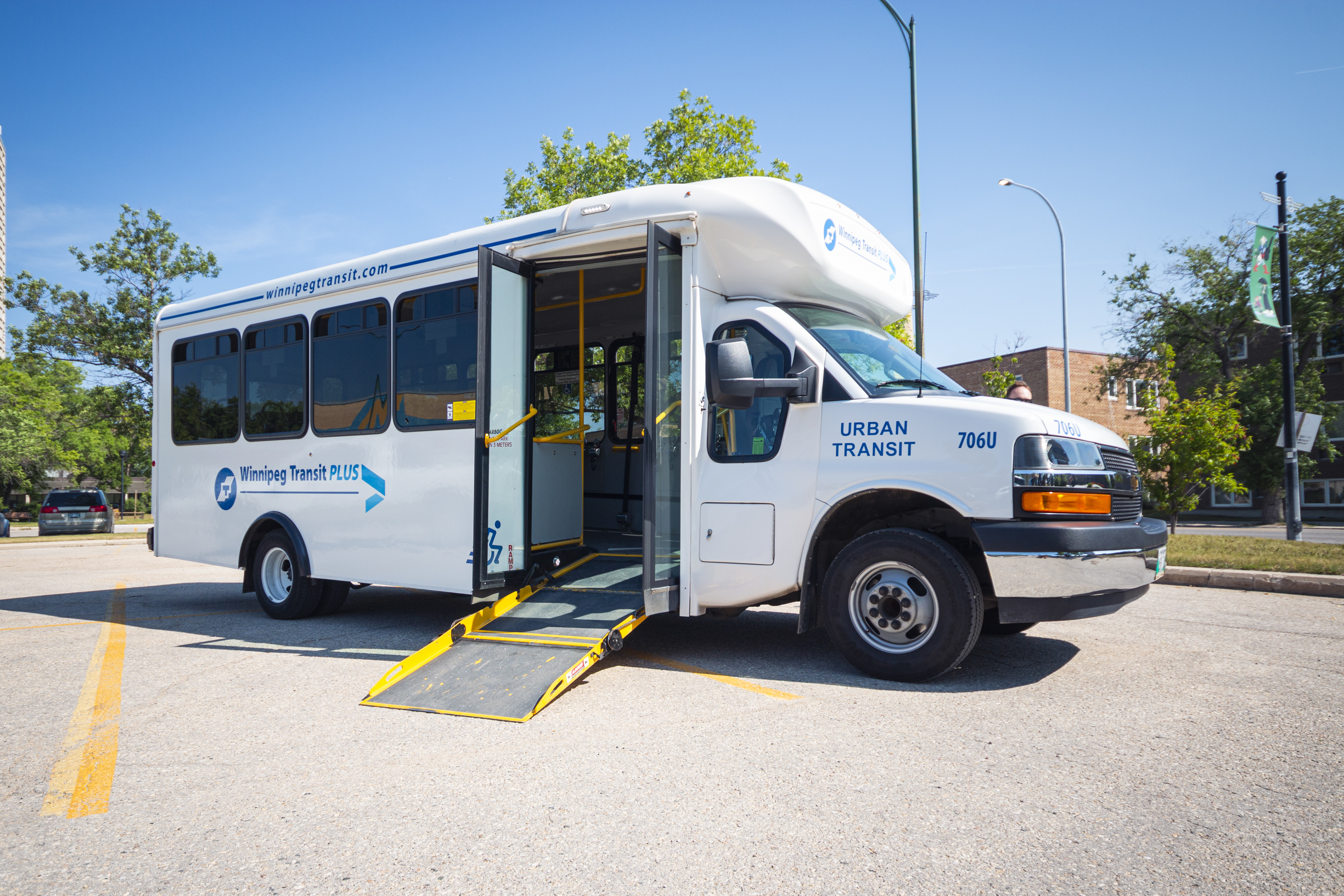 A wheelchair-accessible Winnipeg Transit Plus vehicle with its ramp deployed